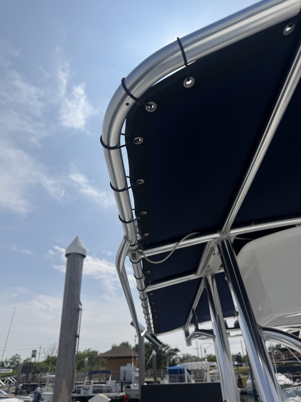 The same T-top tubing polished to a mirror finish, reflecting the sky