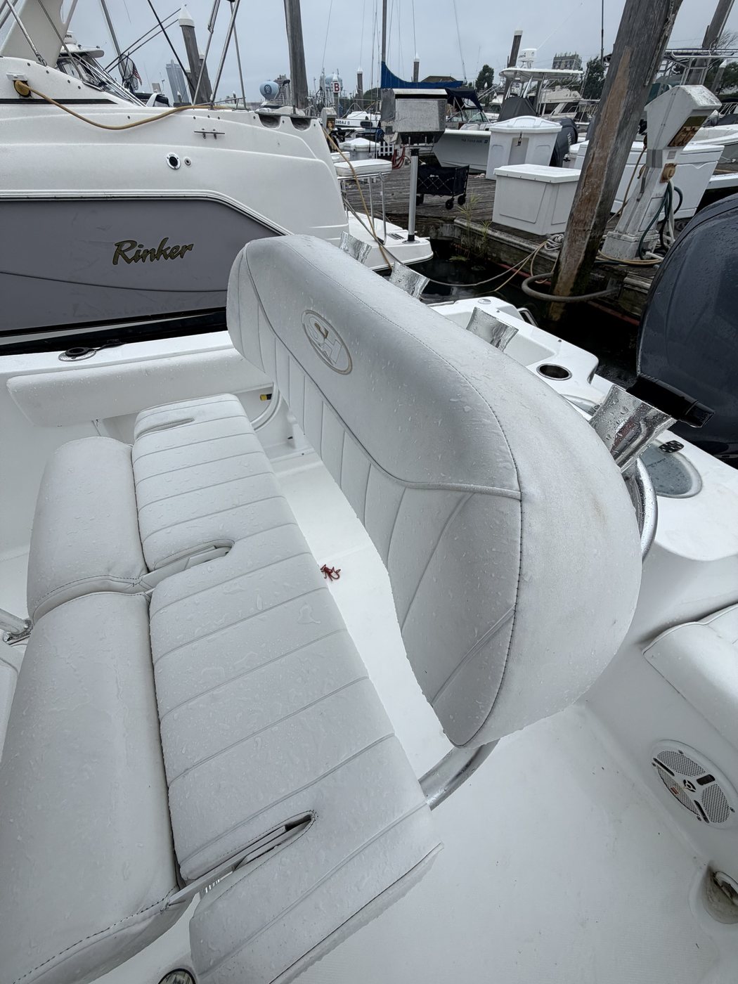 Boat seating with mildew staining and dull, dirty white vinyl before cleaning